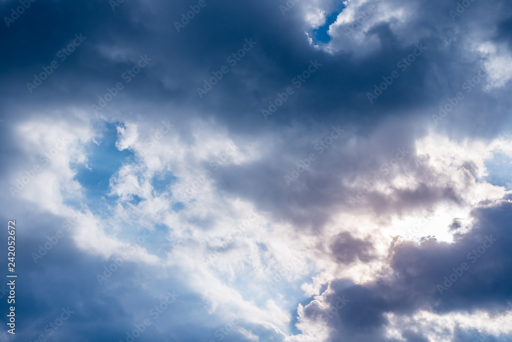 Fototapeta premium Evening sunlight and dark clouds, dramatic background.