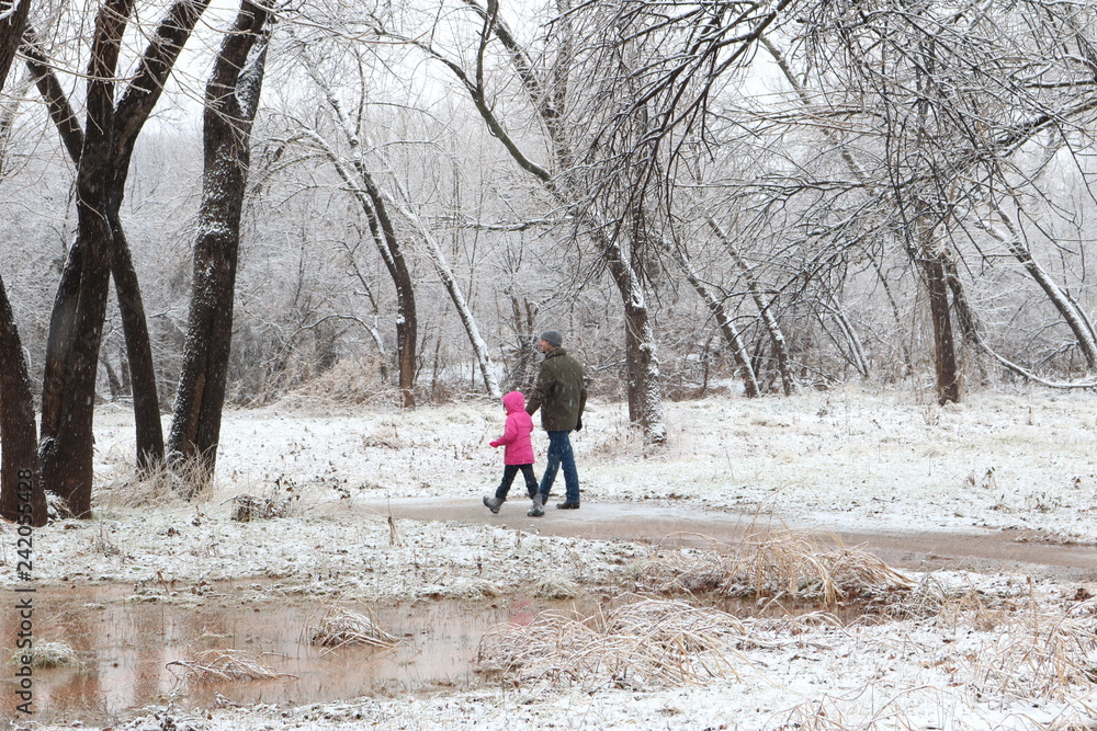 Father and young daughter hiking in the snow Father and young daughter hiking in the snow
