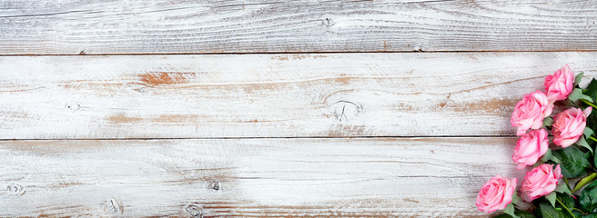 Spring still life with Mothers Day holiday concept on white rustic wood background with pink rose flowers