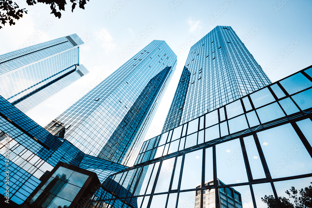 Modern skyscrapers in business district against blue sky