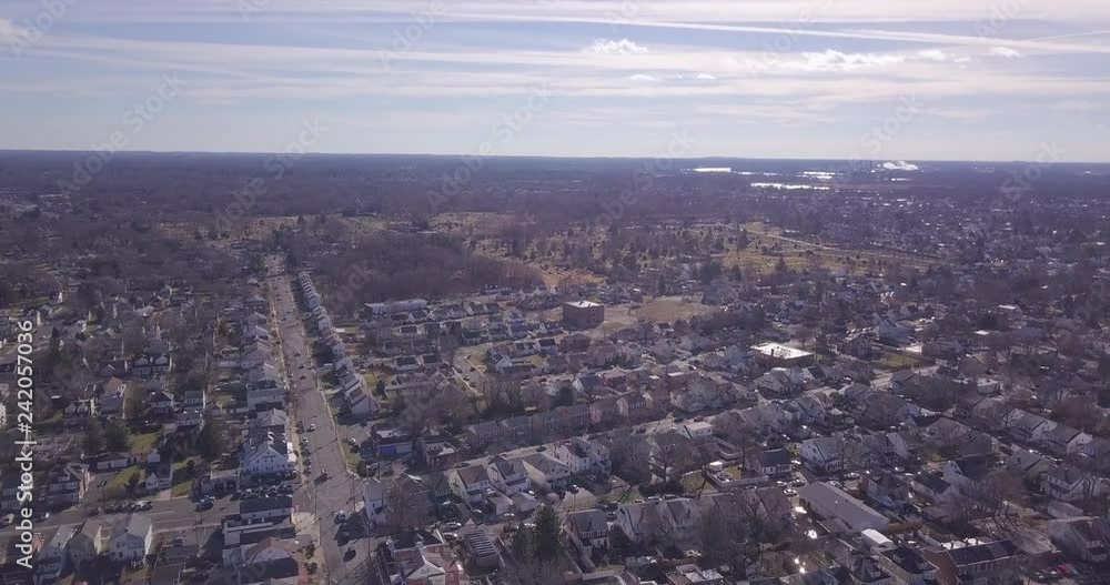 Drone flying high over town sun flare horizon Drone flying high over town sun flare horizon
