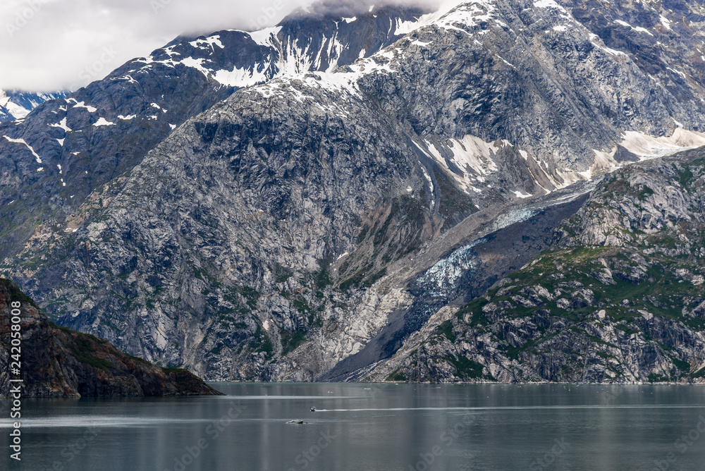Johns Hopkins Glacier and mountains on a cloudy day in Glacier Bay, Alaska