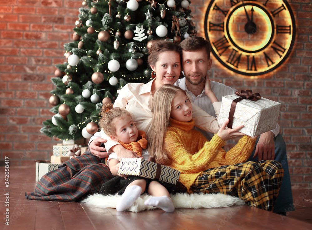 family with Christmas gifts in a cozy living room family with Christmas gifts in a cozy living room