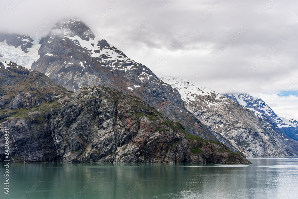 Johns Hopkins Glacier and mountains on a cloudy day in Glacier Bay, Alaska
