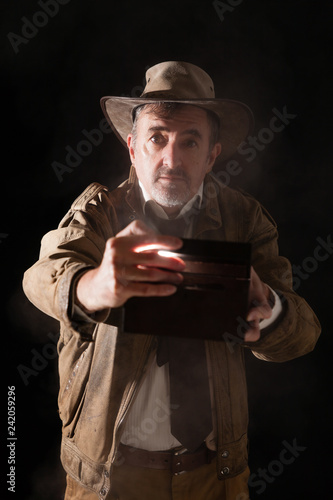 Man in explorer costume with a box in his hands