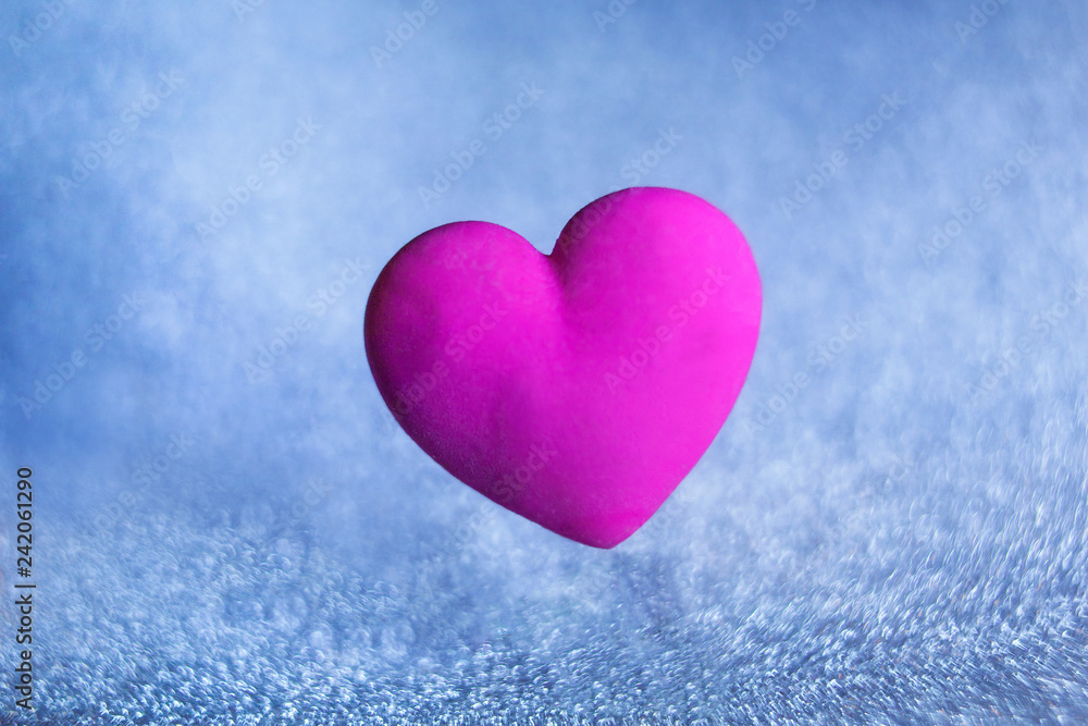 volumetric violet red heart on a blue background of sparkles