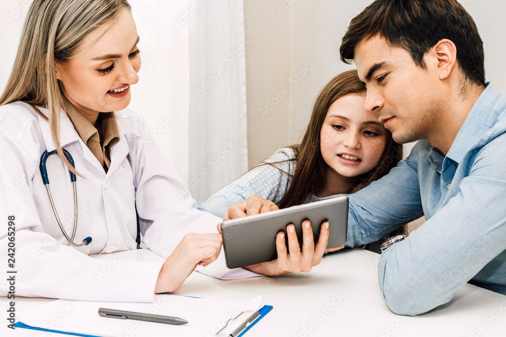 Doctor consulting and check up information with little girl in hospital.A little girl has sick.healthcare and medicine Doctor consulting and check up information with little girl in hospital.A little girl has sick.healthcare and medicine