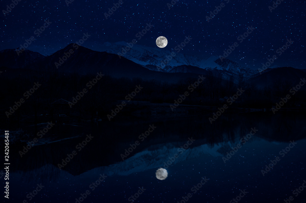 Landscape of gorgeous full moon over the snow-capped mountains reflected in the lake or mysterious night sky with full moon. Azerbaijan Landscape of gorgeous full moon over the snow-capped mountains reflected in the lake or mysterious night sky with full moon. Azerbaijan
