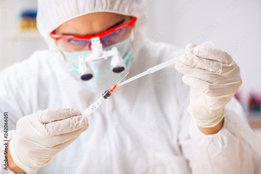 Young expert criminologist working in the lab Young expert criminologist working in the lab