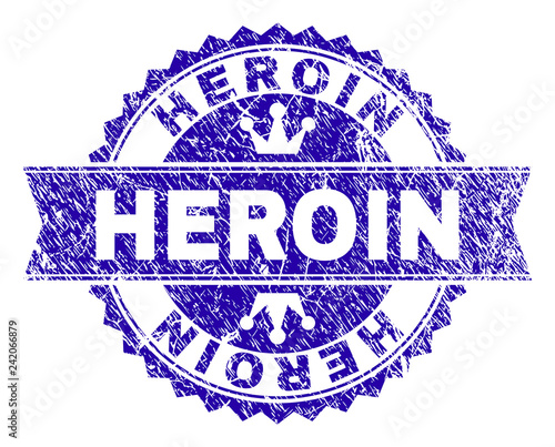 HEROIN rosette stamp seal watermark with grunge style. Designed with round rosette, ribbon and small crowns. Blue vector rubber watermark of HEROIN caption with unclean style.