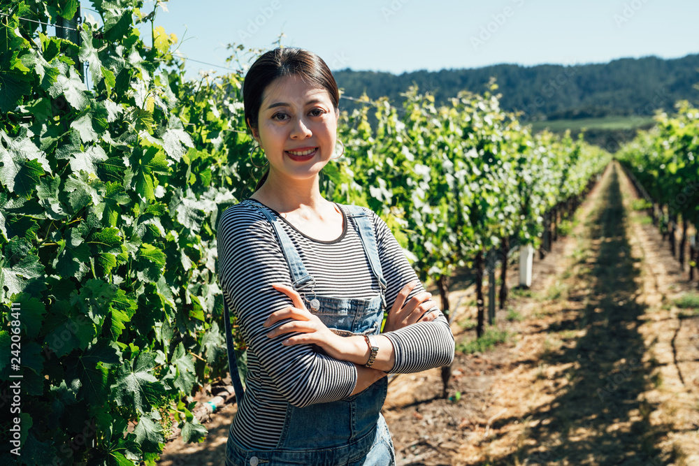 Young female winemaker in vineyard Young female winemaker in vineyard