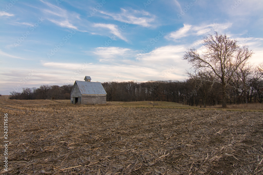 Old wooden barn in open field at sunset. LaSalle County, Illinois, USA Old wooden barn in open field at sunset. LaSalle County, Illinois, USA