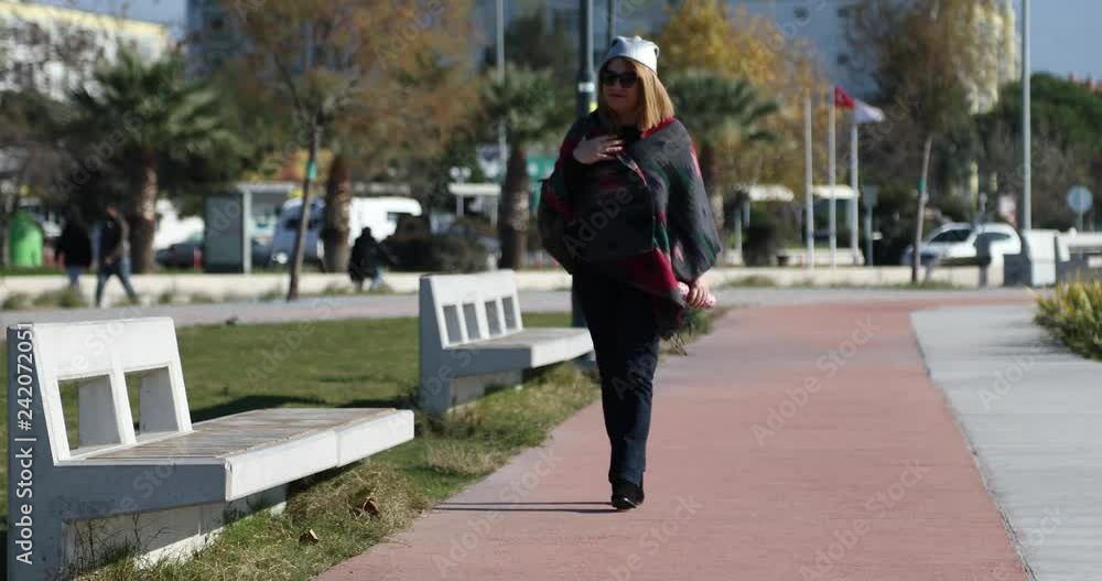 Woman walking in the city park