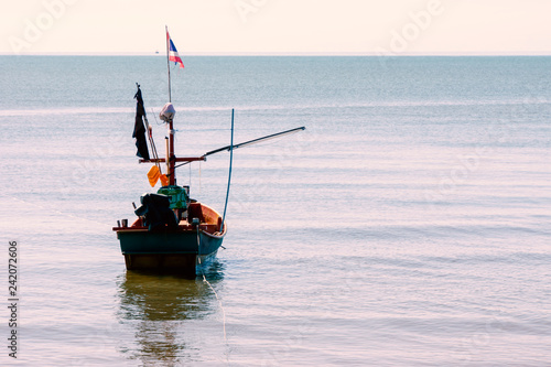 Fishing boat floating on peaceful sea waiting time to go fsihing