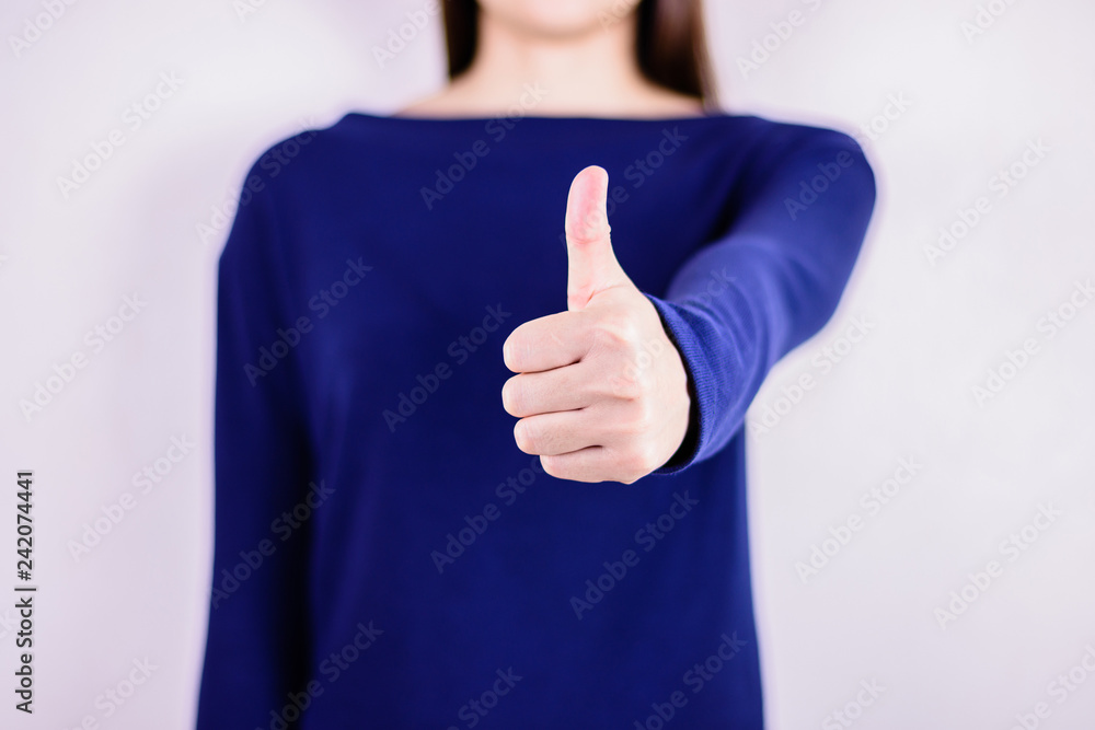 Woman in blue dress giving thumb up. Woman in blue dress giving thumb up.