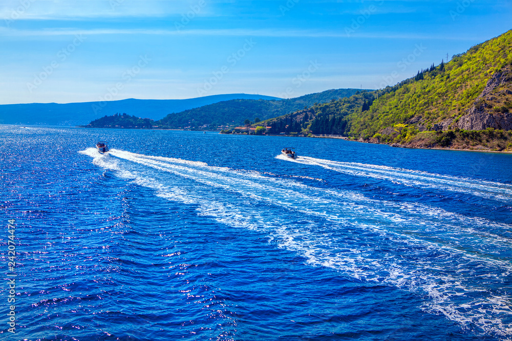 motorboat ride , trail on the blue water surface motorboat ride , trail on the blue water surface