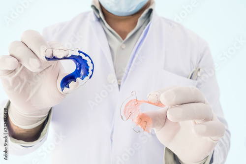 Fototapeta Naklejka Na Ścianę i Meble -  Dentist show dental retainer orthodontic appliance on his hand.