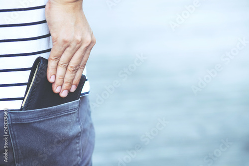 Confident young man posing in safe keeping your wallet in the back pocket of his back pocket pants. savings money.