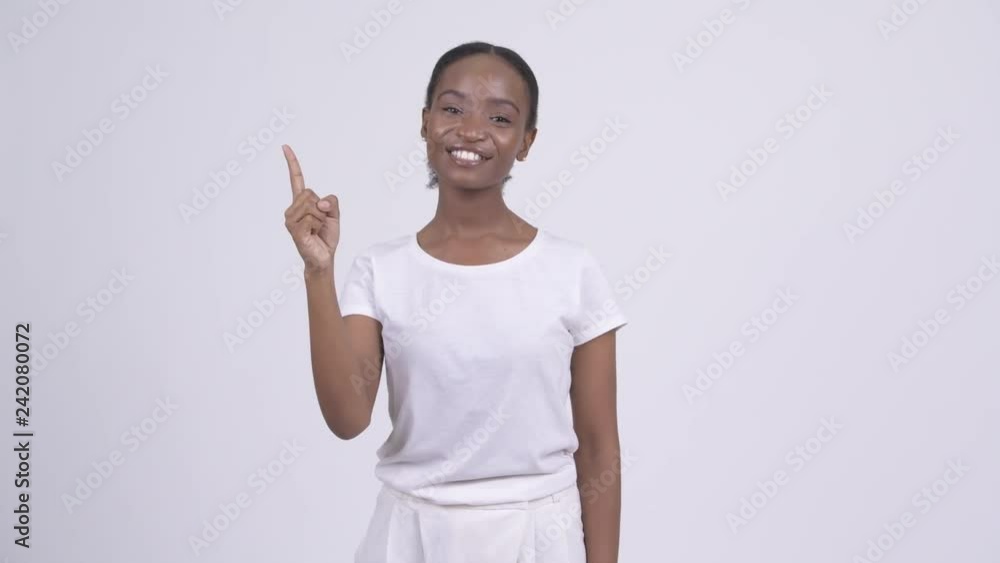 Happy young beautiful African woman pointing up Happy young beautiful African woman pointing up