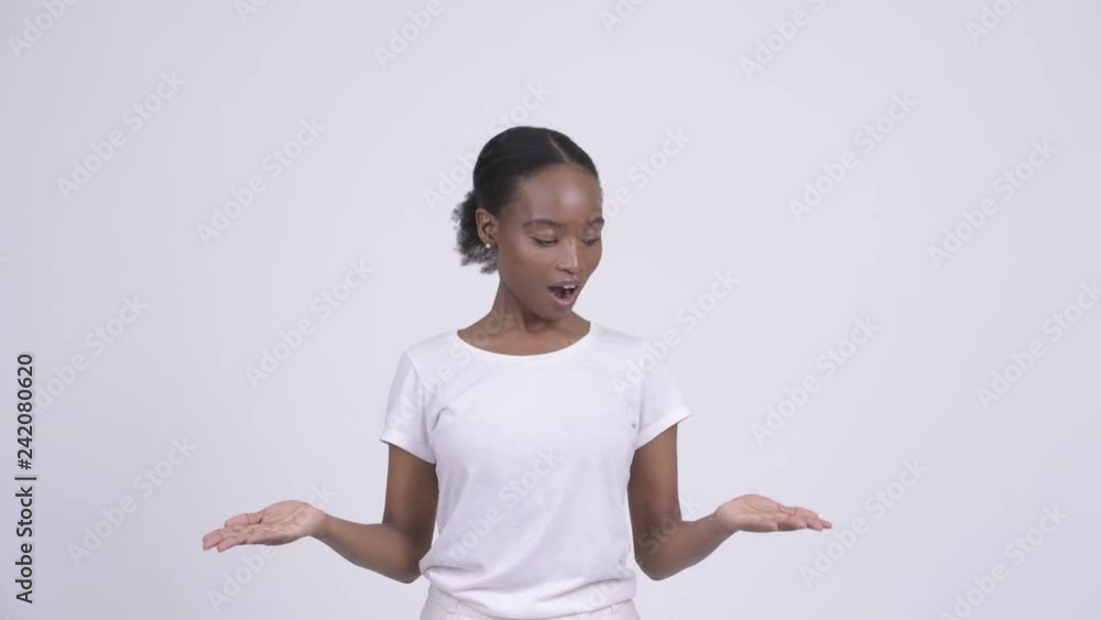 Happy young beautiful African woman catching something Happy young beautiful African woman catching something