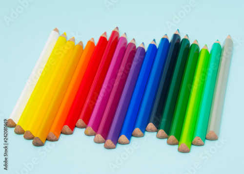 colorful pencils on blue paper