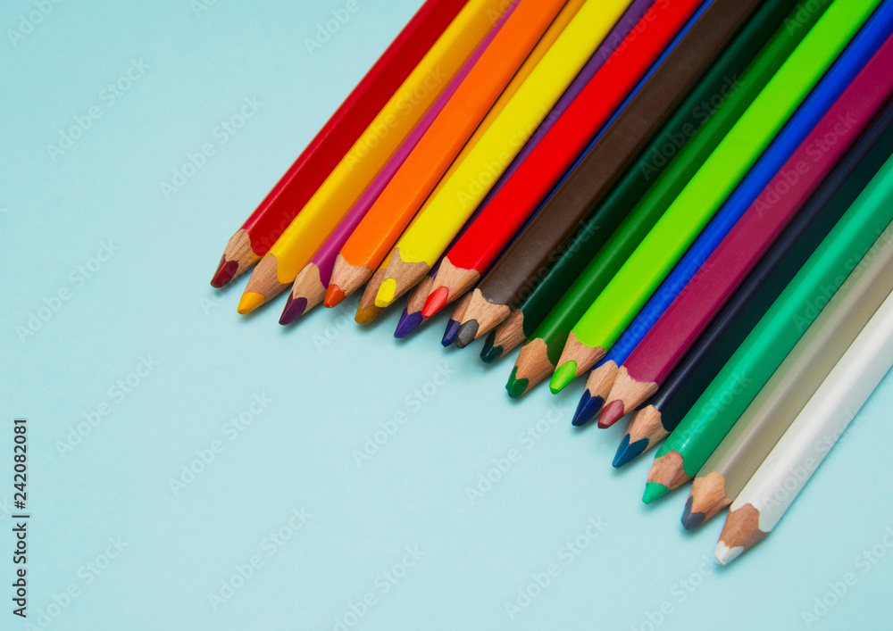 colorful pencils on blue paper colorful pencils on blue paper