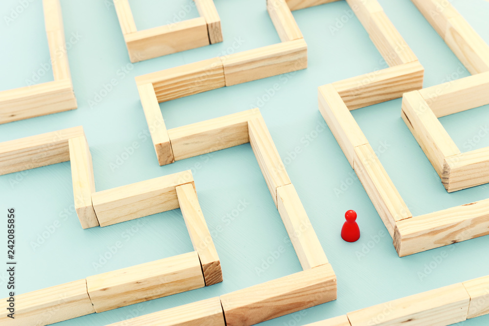 concept photo of standing in a maze and looking for the best way or solution.