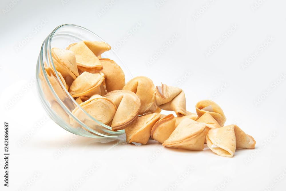 Spilled fortune cookies from bowl Spilled fortune cookies from bowl
