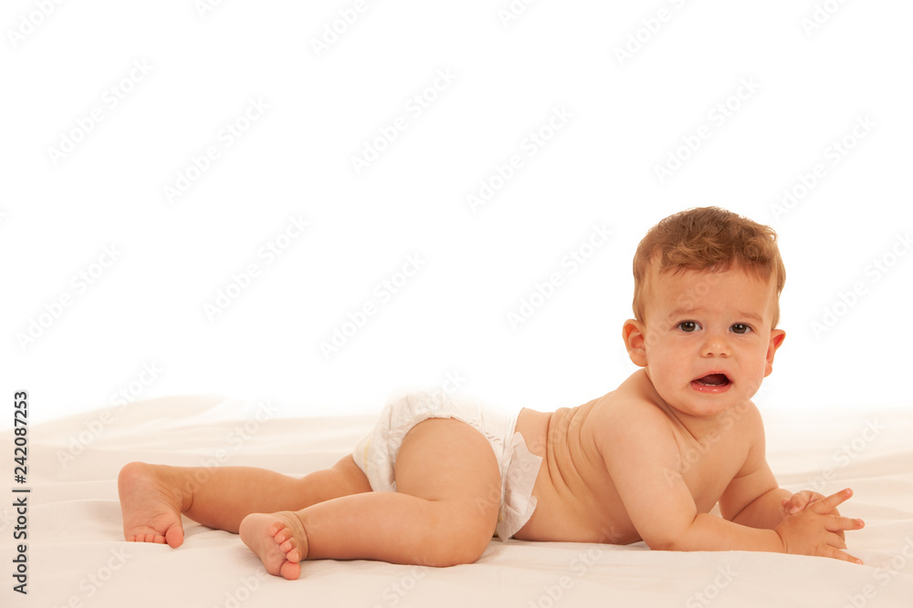 Hapy baby boy in playing on bed isolated over white Hapy baby boy in playing on bed isolated over white