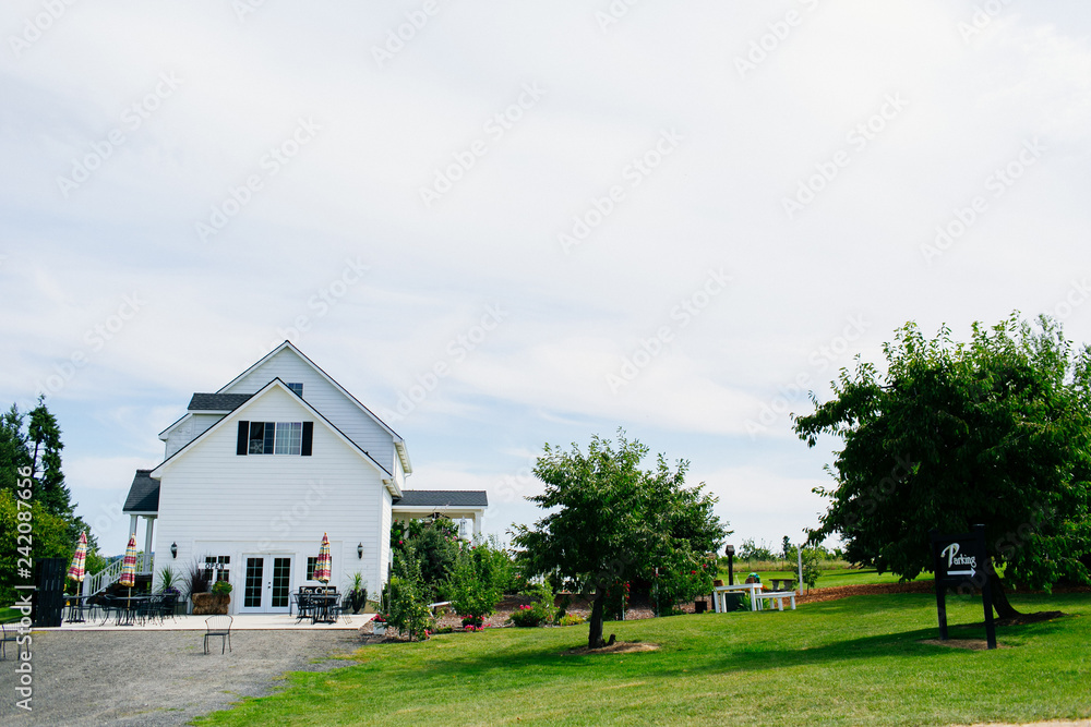 classic white farm house on a farm on a cloudy day classic white farm house on a farm on a cloudy day