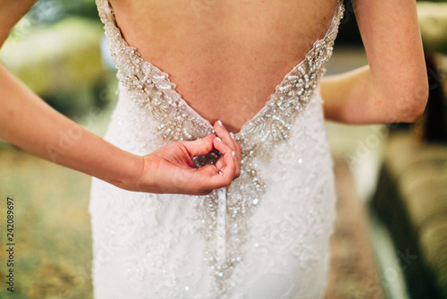 Tablou pe pânză bride getting ready zipping up wedding dress