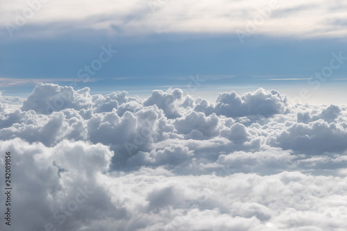 Fototapeta Naklejka Na Ścianę i Meble -  Above fluffy clouds with blue sky from airplane