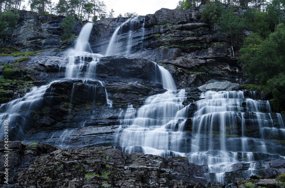 Tvindefossen waterfall in Norway photographed on long exposure during dusk