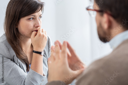 Sad beautiful young woman with social problems during psychotherapy