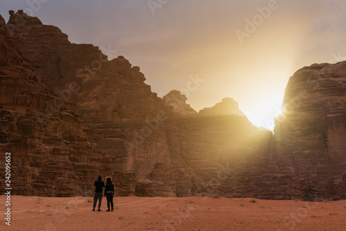 Couple travelling in Wadi Rum desert in Jordan  enjoying beautiful sunrise in the morning