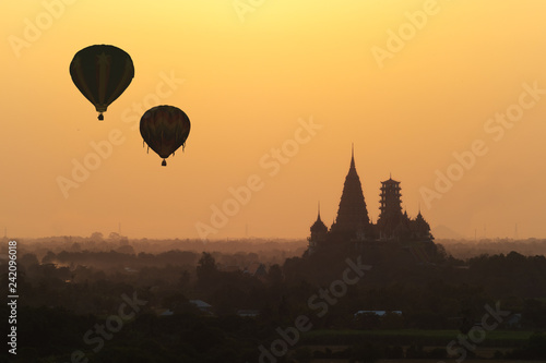 Hot air balloon flying over Wat Tham Sua (Tiger Cave Temple) in Kanchanaburi, Thailand