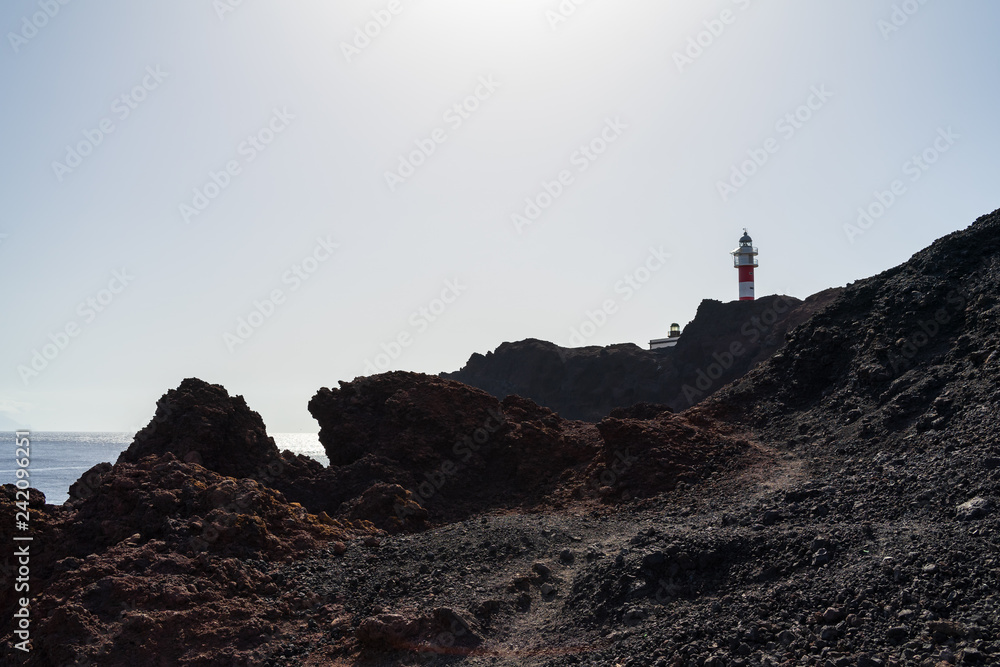 Lighthouse on the rocky shore of the Atlantic Ocean. Cape Teno (Punta de Teno). Tenerife. Canary Islands. Spain.