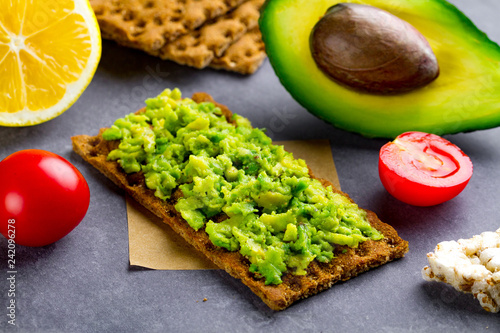 Avocado sandwich with avocado cream and rye crisp bread for snack. Fiber, fitness and diet food.