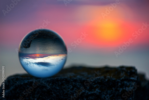  Upside down sunset landscape at Cape Kaliakra, Bulgaria, Eastern Europe - reflection in a lensball - selective focus, space for text photo