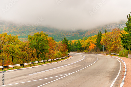 car mountain road in the autumn Crimea, low clouds on a cloudy day