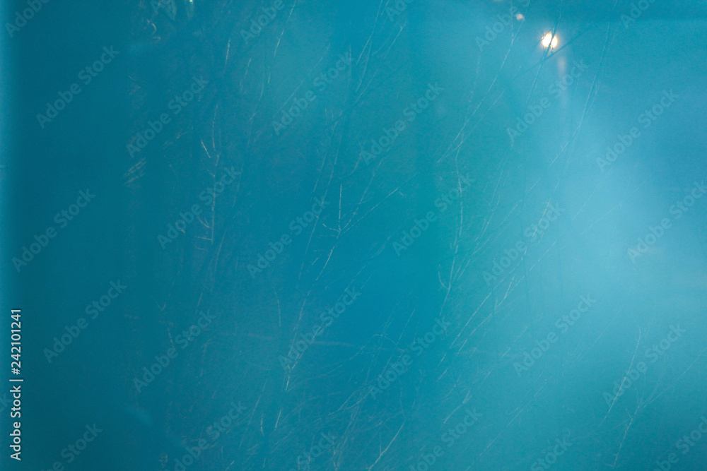 Turquoise texture background with glare from the lantern.