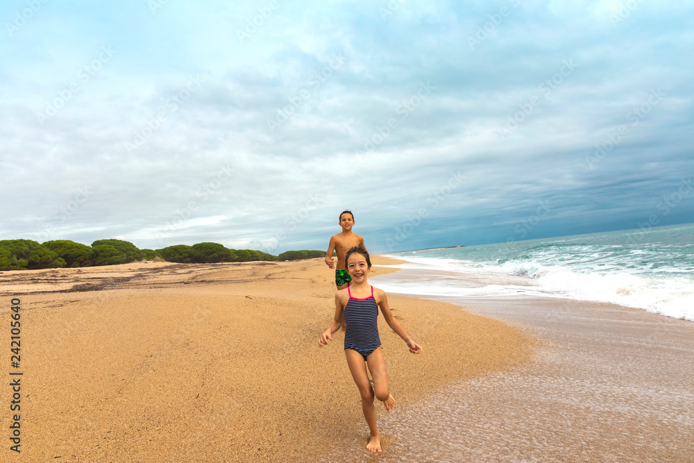 Kids playing on the beach. Active and  healthy childhood.