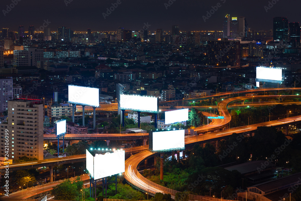 Blank billboard on the highway during the twilight with city background
