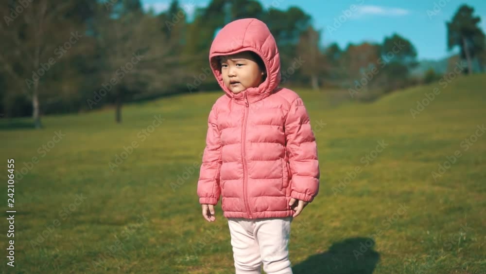 Asian chinese toddler feeling sad outdoors