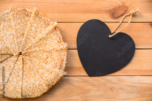 Top view of crepes (french pancakes), blank heart with copy space, rustic wood background