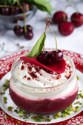 Creamy cherry dessert with pistaccio close up photo