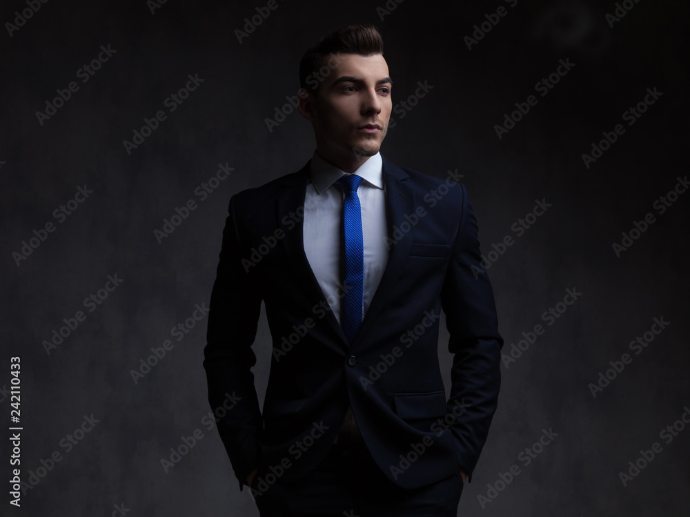 portrait of relaxed businessman in navy suit looking to side portrait of relaxed businessman in navy suit looking to side