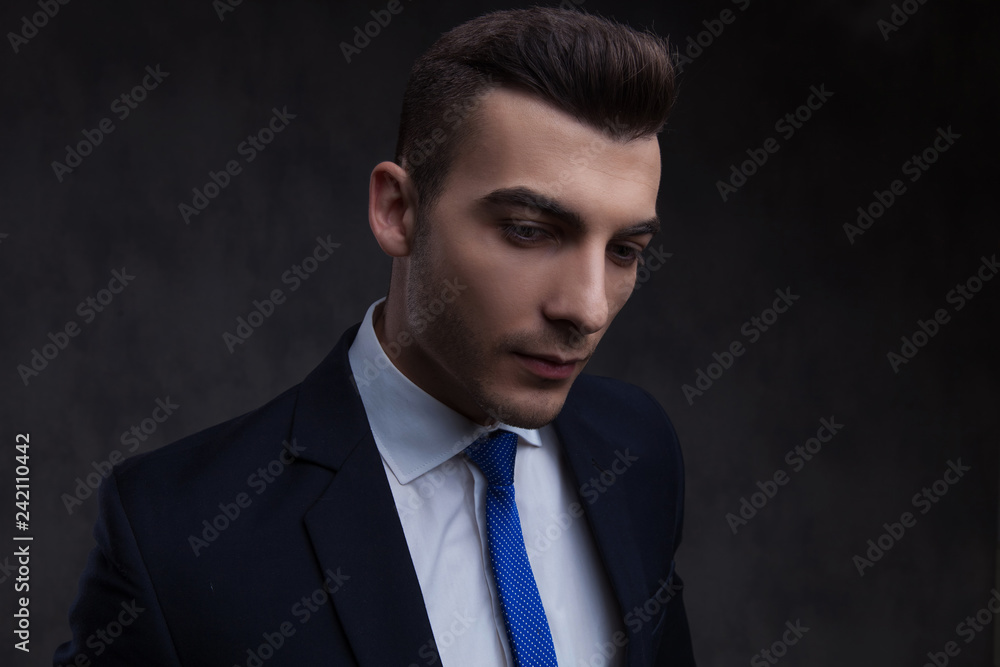 portrait of curious smart casual man looking down to side portrait of curious smart casual man looking down to side