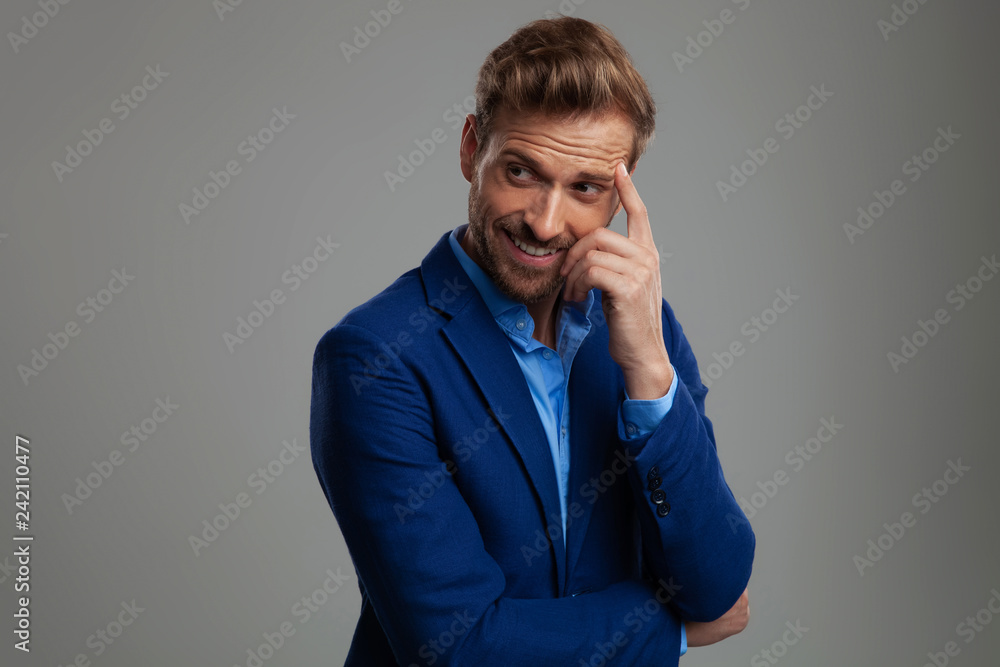 happy smart casual man thinking and looking to side happy smart casual man thinking and looking to side