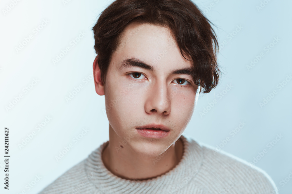 Studio portrait young man in grey sweater on white background Studio portrait young man in grey sweater on white background